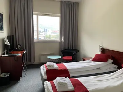 a hotel room with two beds and a window at Sitla Hotel & Apartments in Øvre Årdal