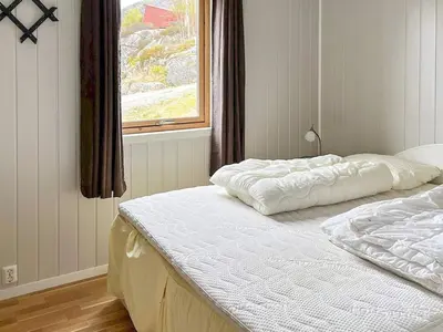 two twin beds in a bedroom with a window at 6 person holiday home in Ånneland-By Traum in Ånneland