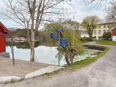 a street sign in front of a body of water at 6 person holiday home in Ånneland-By Traum in Ånneland