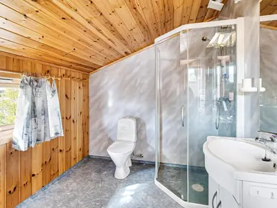 a bathroom with a shower and a toilet and a sink at 6 person holiday home in Ånneland-By Traum in Ånneland