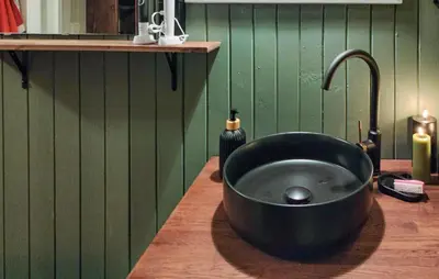 a black sink in a kitchen with green walls at 2 Bedroom Awesome Home In Lillehammer in Lillehammer