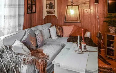 a living room with a couch and a table at 2 Bedroom Awesome Home In Lillehammer in Lillehammer