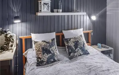 a bedroom with a bed with two pillows on it at 2 Bedroom Awesome Home In Lillehammer in Lillehammer