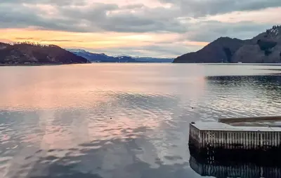a view of a lake with a dock in the water at 3 Bedroom Nice Home In Os in Oma