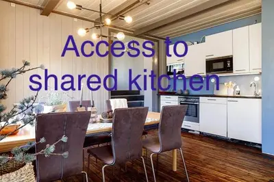 a kitchen with a table and chairs in a room at Fossheim Lodge Nr 10 in Torset