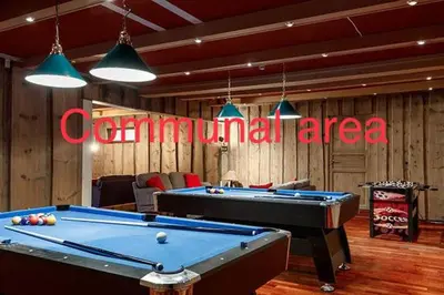 a room with two pool tables and a neon sign at Fossheim Lodge Nr 10 in Torset