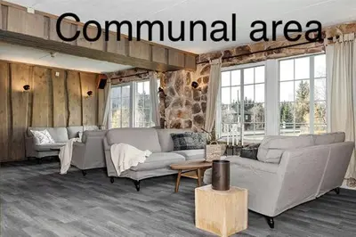 a living room with couches and a communication area at Fossheim Lodge Nr 10 in Torset