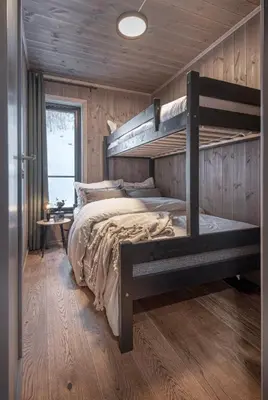 a bedroom with two bunk beds in a cabin at Ground Floor Exclusive Apartment with Sauna - Near Geiranger and the Norwegian Fjords in Stranda
