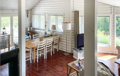 a kitchen and dining room with a table and chairs at Beach Front Home In Førde I Hordaland in Erve