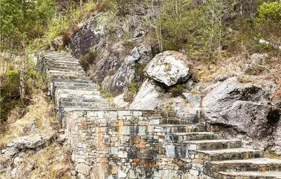 an old stone wall on the side of a mountain at Beach Front Home In Førde I Hordaland in Erve