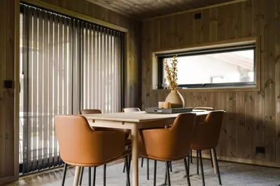 a dining room with a table and chairs at Exclusive Nordic Apartment with Sauna - Prime Location at Stranda near Geiranger in Stranda
