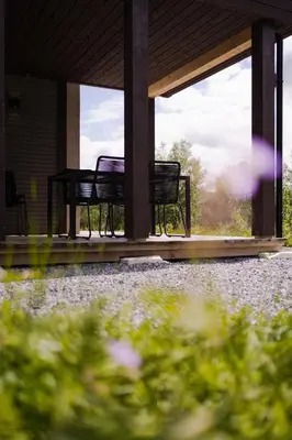 three chairs sitting on the porch of a house at Exclusive Nordic Apartment with Sauna - Prime Location at Stranda near Geiranger in Stranda