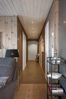 a hallway of a room with a couch and a table at Bualie - Golsfjellet - Biking, swimmming, hiking. High standard. in Gol