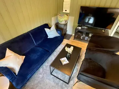 a living room with a blue couch and a table at 4 person holiday home in OMASTRAND-By Traum in Sanddal