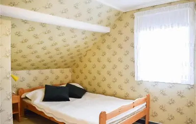a bedroom with a bed and a window at Beautiful Home In Sveio With Wifi in Sveio