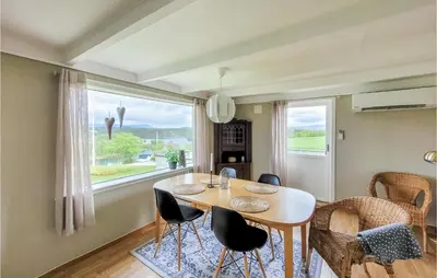 a dining room with a table and chairs and a window at Beautiful Home In Sveio With Wifi in Sveio