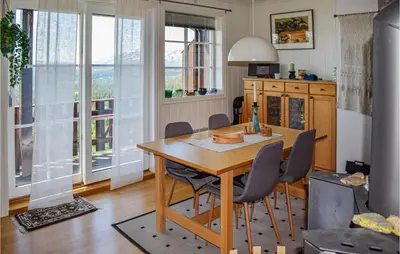 a dining room with a wooden table and chairs at Awesome Apartment In Rauland With Sauna in Rauland