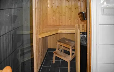a sauna with a wooden stool and a wooden chair at Awesome Apartment In Rauland With Sauna in Rauland