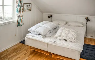 a white bed with white sheets and pillows on it at Awesome Apartment In Rauland With Sauna in Rauland