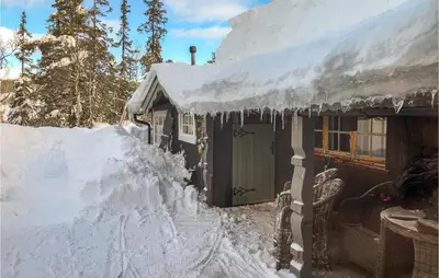 a house covered in snow with icicles on it at Nice Home In Tuddal With Kitchen in Tuddal