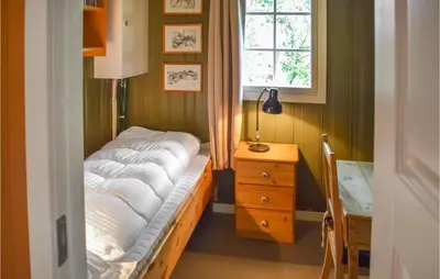 a small bedroom with a bed and a window at Nice Home In Tuddal With Kitchen in Tuddal