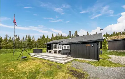 a small black building with a porch and a flag at 3 Bedroom Amazing Home In Lillehammer in Lillehammer
