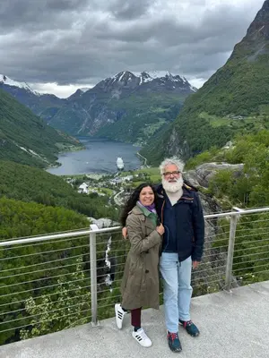 a man and a woman standing on top of a mountain at Beach front appartments in design eco-villa in Ulsteinvik
