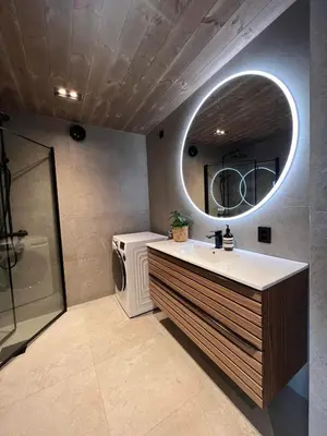 a bathroom with a sink and a washing machine at Rindabotten Panorama in Sogndal