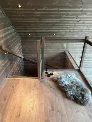 a room with a staircase with a furry rug on the floor at Rindabotten Panorama in Sogndal