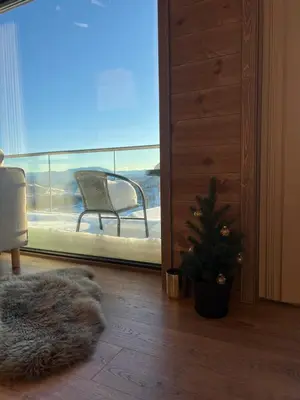 a living room with a christmas tree in front of a window at Rindabotten Panorama in Sogndal