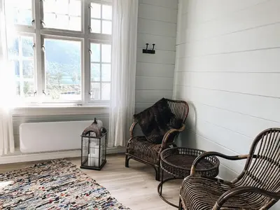 a living room with two chairs and a bath tub at Valldal Sentrum Overnatting in Valldal