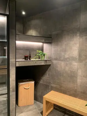 a bathroom with a shelf and a bench in it at Olden apartments 3, penthouse. in Olden