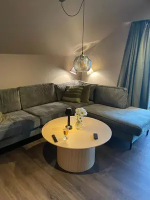 a living room with a couch and a table at Olden apartments 3, penthouse. in Olden
