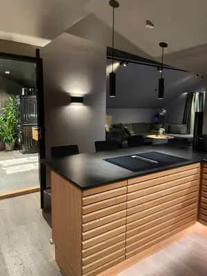 a kitchen with a large island with black counter top at Olden apartments 3, penthouse. in Olden