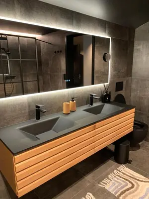 a bathroom with a sink and a large mirror at Olden apartments 3, penthouse. in Olden