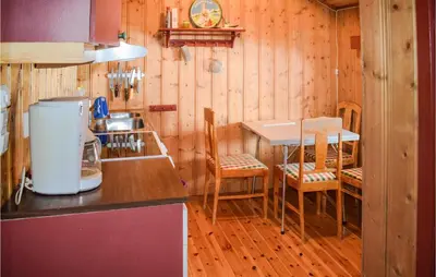 a kitchen with a counter and a table and chairs at Nice Home In Rauland With Kitchen in Rauland