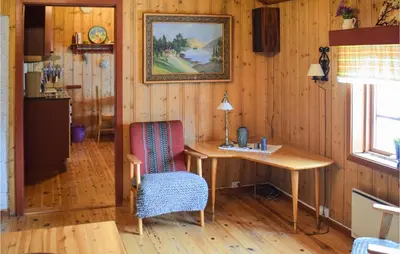 a room with a table and a chair and a picture at Nice Home In Rauland With Kitchen in Rauland
