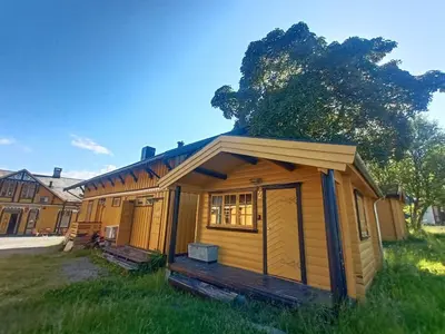 a large wooden cabin in a field of grass at LUBBENES GÅRD in Molde