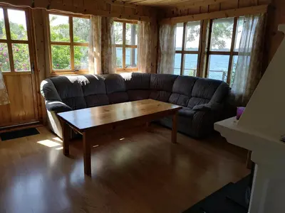 a living room with a couch and a coffee table at Fanafjorden Cabins in Bergen