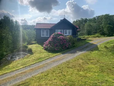 a small house on a hill with a dirt road at 6 person holiday home in Ånneland-By Traum in Ånneland