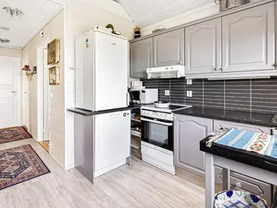 a kitchen with white cabinets and white appliances at 6 person holiday home in Ånneland-By Traum in Ånneland