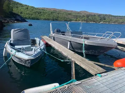 two boats are docked at a dock in the water at 6 person holiday home in Ånneland-By Traum in Ånneland