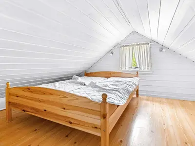 a bedroom with a bed in a white room at 6 person holiday home in Ånneland-By Traum in Ånneland