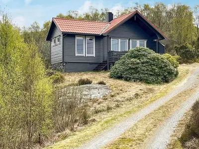 a small house on a hill with a dirt road at 6 person holiday home in Ånneland-By Traum in Ånneland