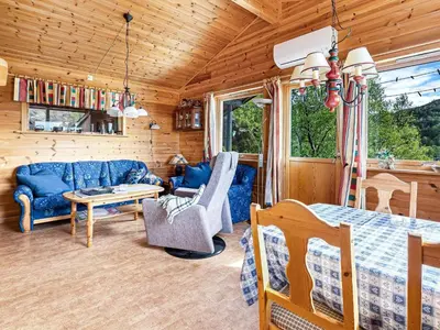 a room with a bed and a couch and a table at 6 person holiday home in Ånneland in Ånneland