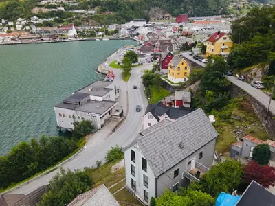 an aerial view of a town next to a river at Odda City Apartments in Odda