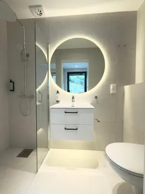 a bathroom with a sink and a toilet and a mirror at Odda City Apartments in Odda