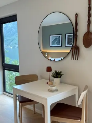 a white table and a mirror in a room at Odda City Apartments in Odda