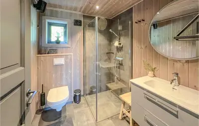 a bathroom with a shower and a toilet and a sink at Gorgeous Home In Gålå With Sauna in Gålå