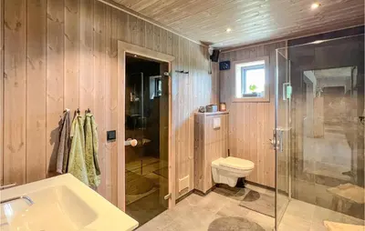 a bathroom with a shower and a toilet and a sink at Gorgeous Home In Gålå With Sauna in Gålå